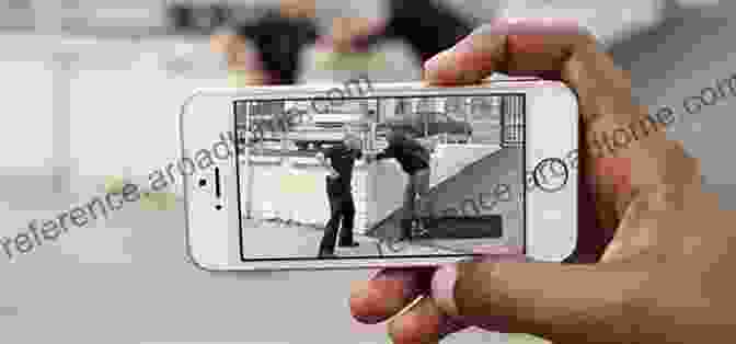 A Person Using A Smartphone To Record A Police Interaction Cop Watch: Spectators Social Media And Police Reform (Psychology Crime And Justice)