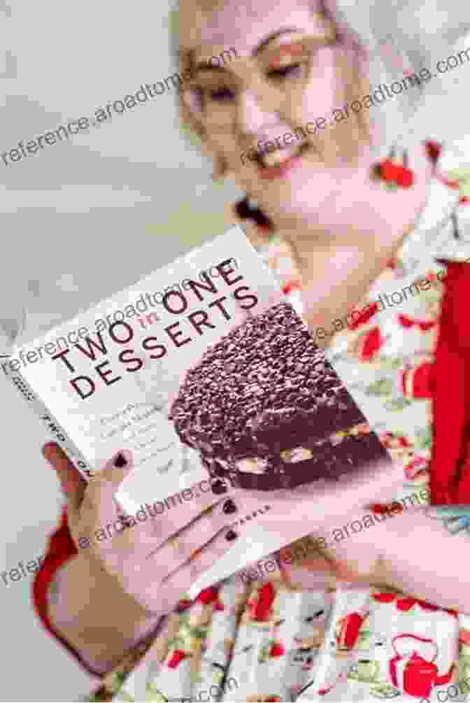 Olivia Wood, The Author Of The Taste Of Belgium, Holding A Copy Of Her Cookbook. The Taste Of Belgium Olivia Wood